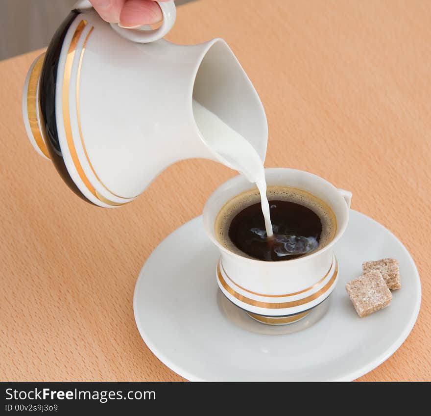 Pouring milk into coffee