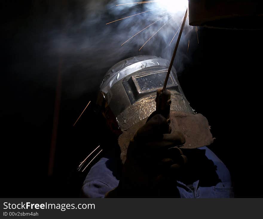 A welder working at shipyard at night. A welder working at shipyard at night