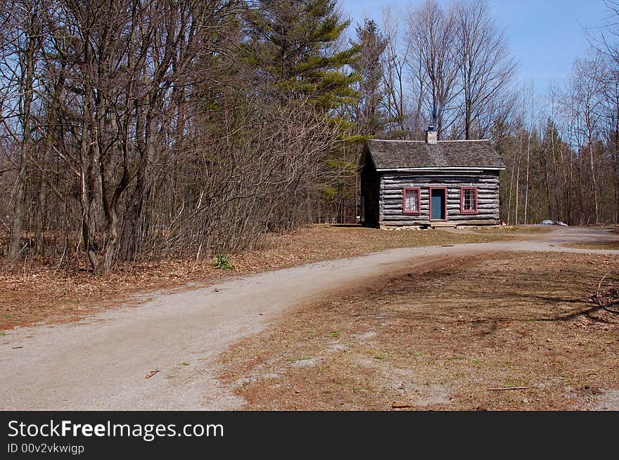 An image of a pathway leading to a cabin under a sunny day. An image of a pathway leading to a cabin under a sunny day.