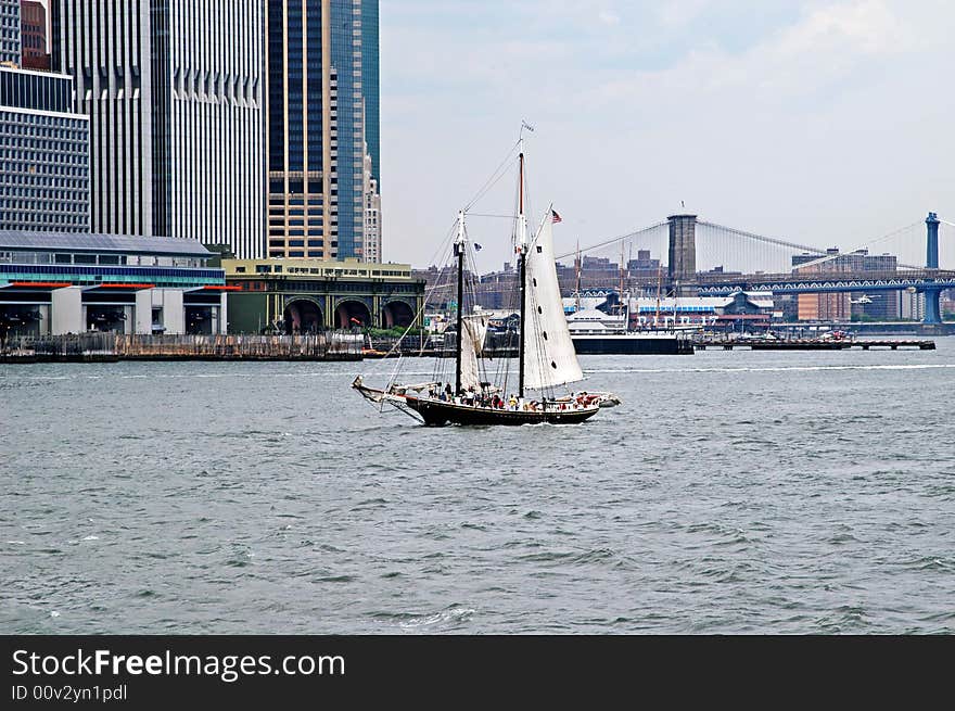 A view of manhattan building and bridge in new york with a beautiful ship. A view of manhattan building and bridge in new york with a beautiful ship