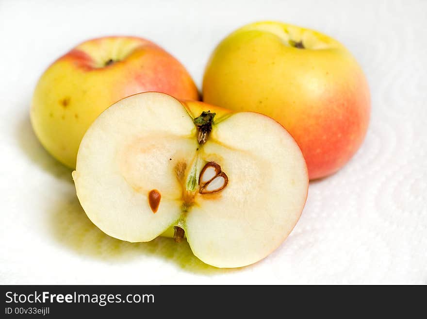 Closeup of three lady apples, one sliced in half