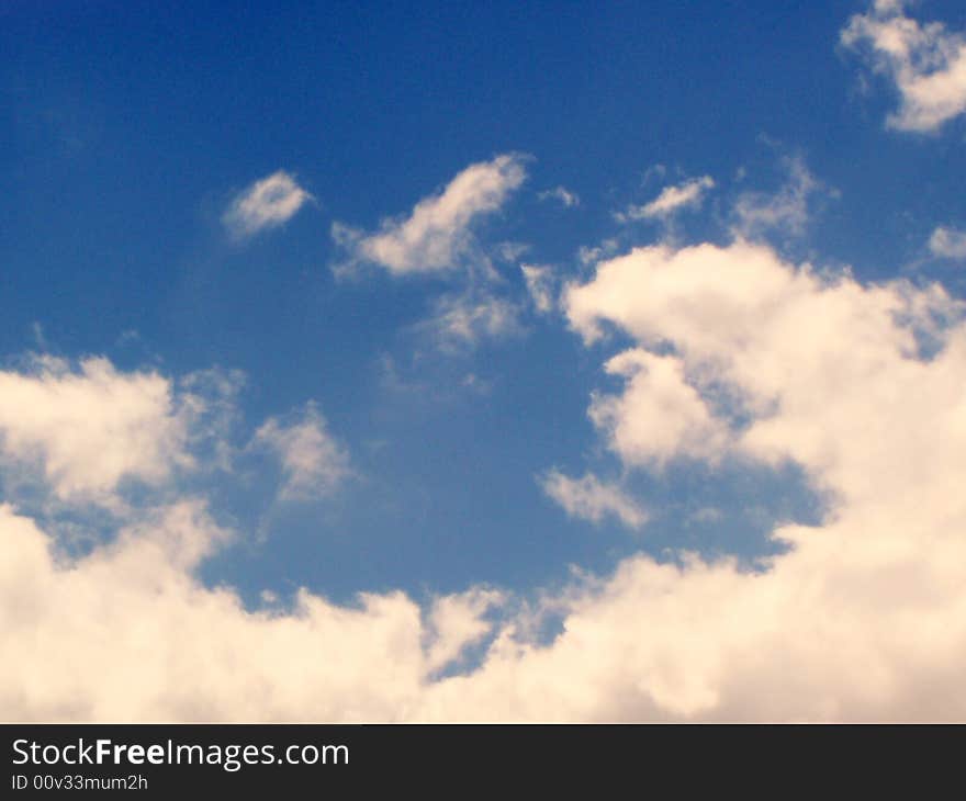 Fluffy clouds in a clear blue sky. Fluffy clouds in a clear blue sky.