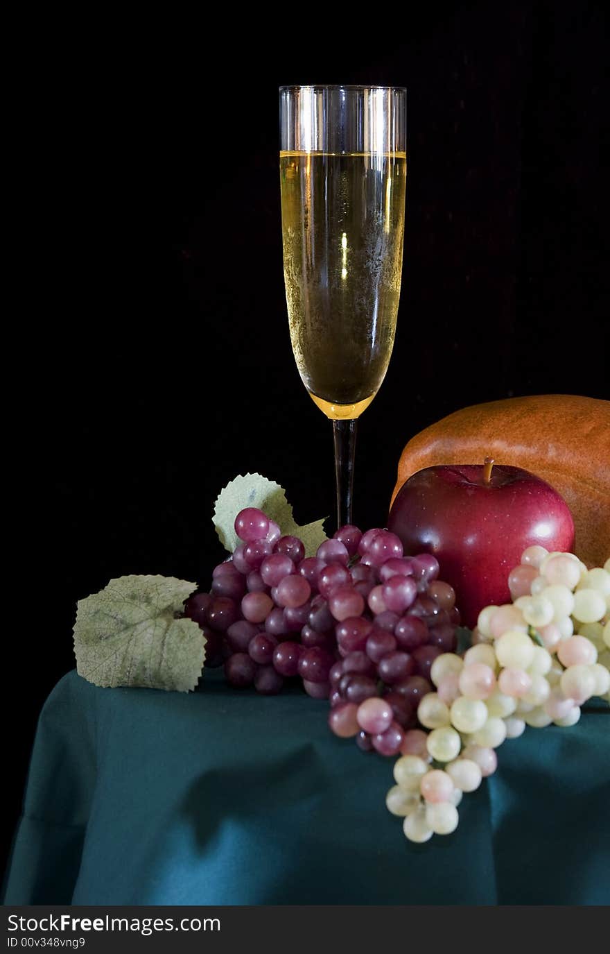 Champagne Glass with surrounding bread and fruit. Champagne Glass with surrounding bread and fruit