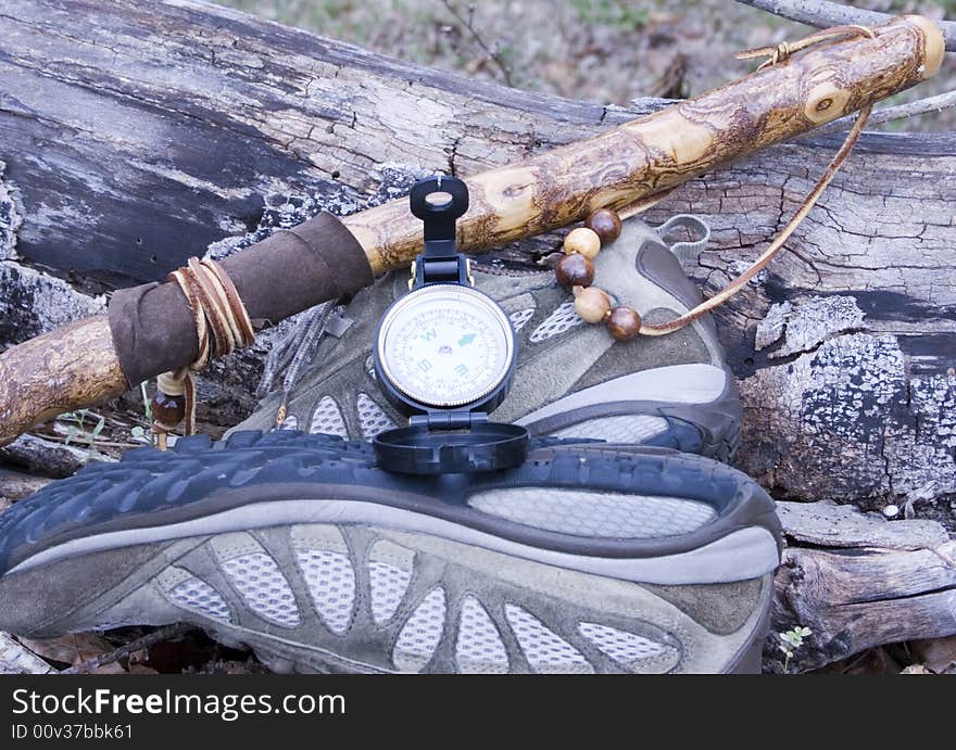 Hicking shoes, walking stick and compass