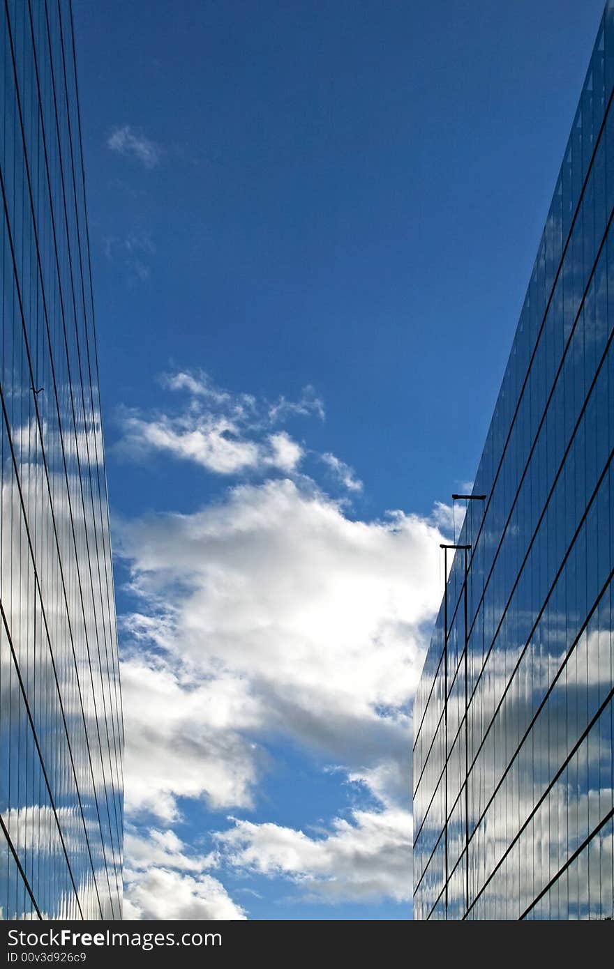 Glass buildings with sky reflections and cloudscape