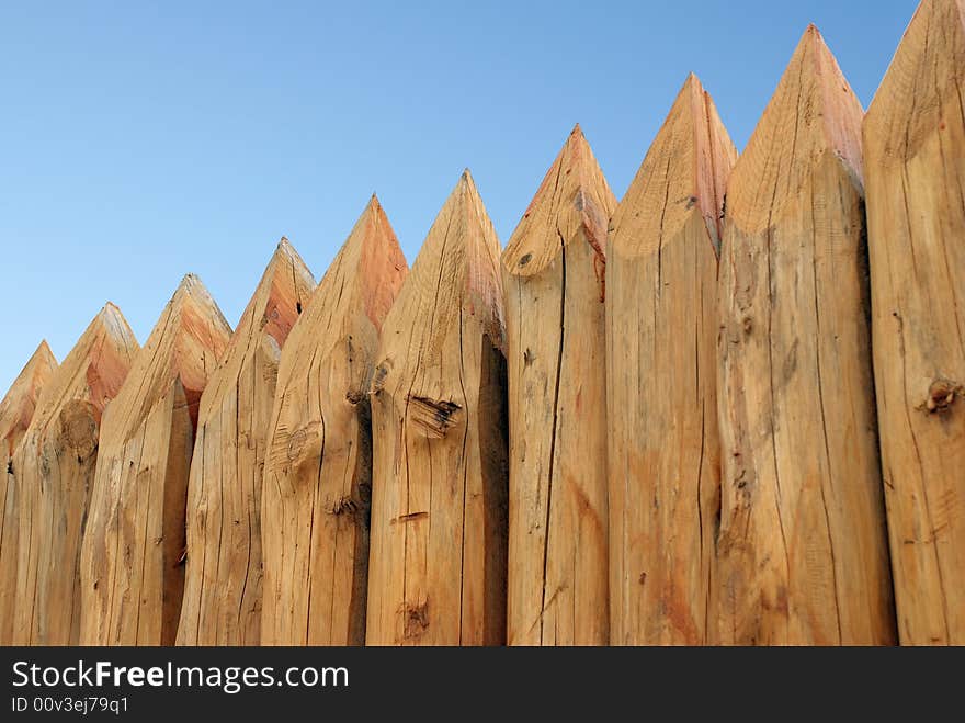 Wooden paling from the sharp raw logs