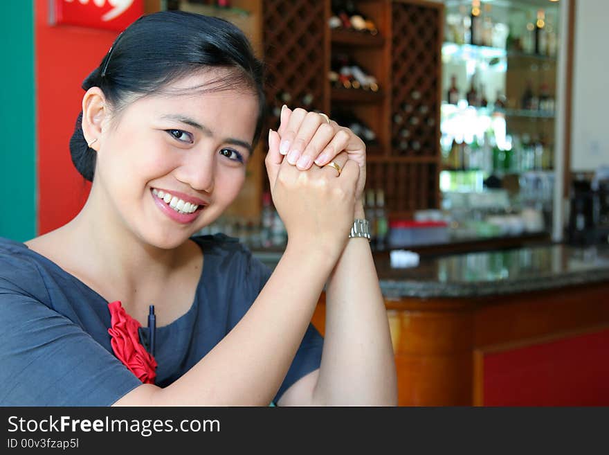 Photograph of bartender, bar at background