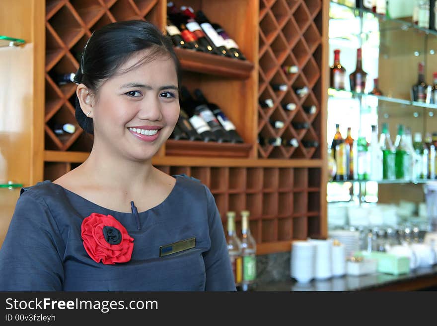 Photograph of bartender smiling at work