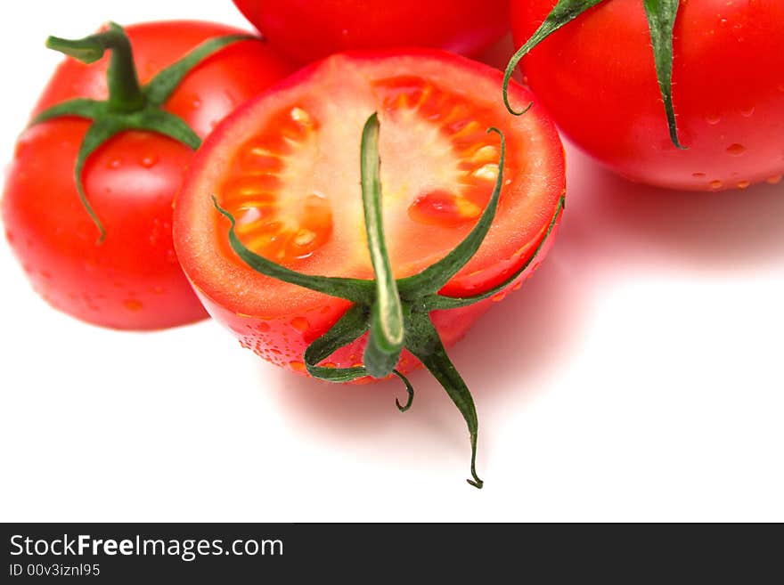 Perfect the tomatoes covered by drops of water are juicy. Isolation on white. Shallow DOF. Perfect the tomatoes covered by drops of water are juicy. Isolation on white. Shallow DOF.