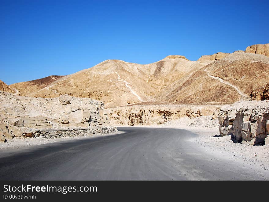 Road through the desert and sandy hills - valley of the kings in Luxor (ancient Thebes), Egypt. Road through the desert and sandy hills - valley of the kings in Luxor (ancient Thebes), Egypt