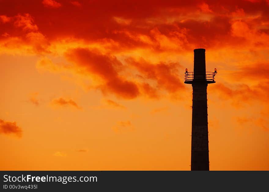 Industrial chimney at sunset