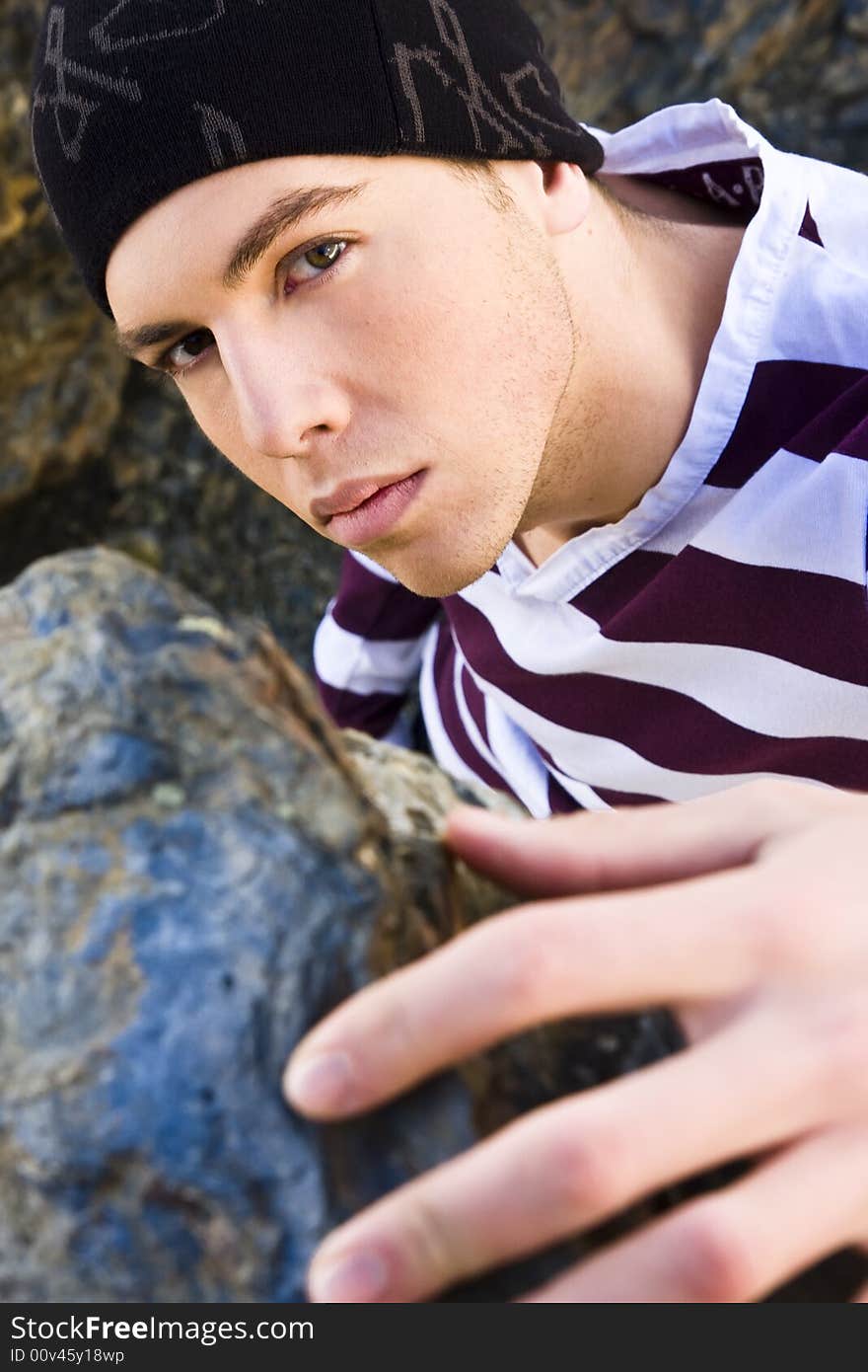 Young man portrait in casual clothing on the rocks. Young man portrait in casual clothing on the rocks