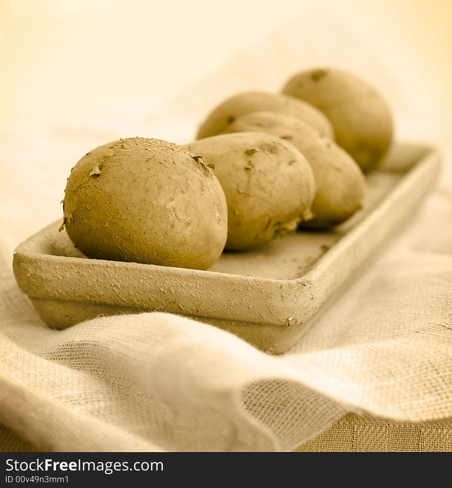 Five raw potatoes (seepia toning)