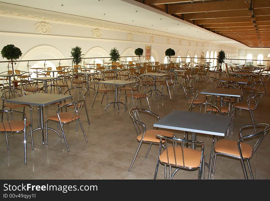 Empty cafe. Nobody in, metal chairs, metal tables.