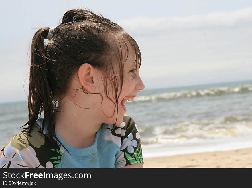 Young girl laughing on the beach