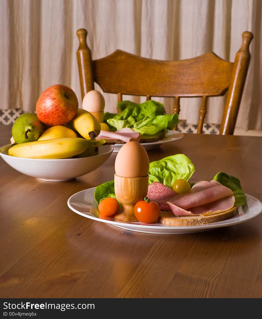 Table served with snacks. Fruits, vegetables, bread, egg, ham etc. Table served with snacks. Fruits, vegetables, bread, egg, ham etc.