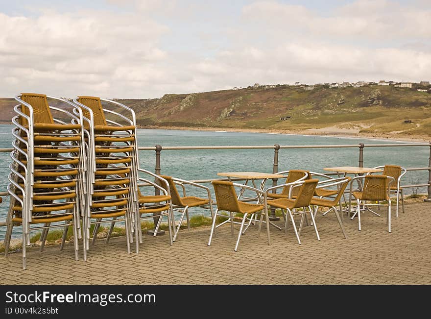 Stacked chairs by the beach