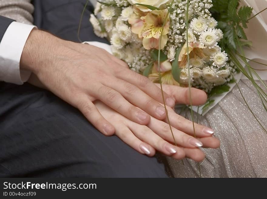 Newly-married couple with wedding bouquet