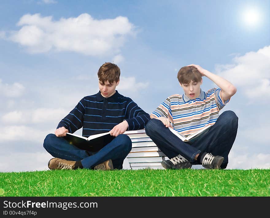 The two students with the book on a background of the blue sky