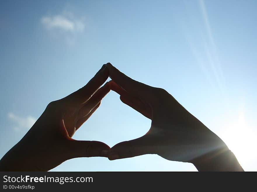 Womans hands on a sky background. Womans hands on a sky background