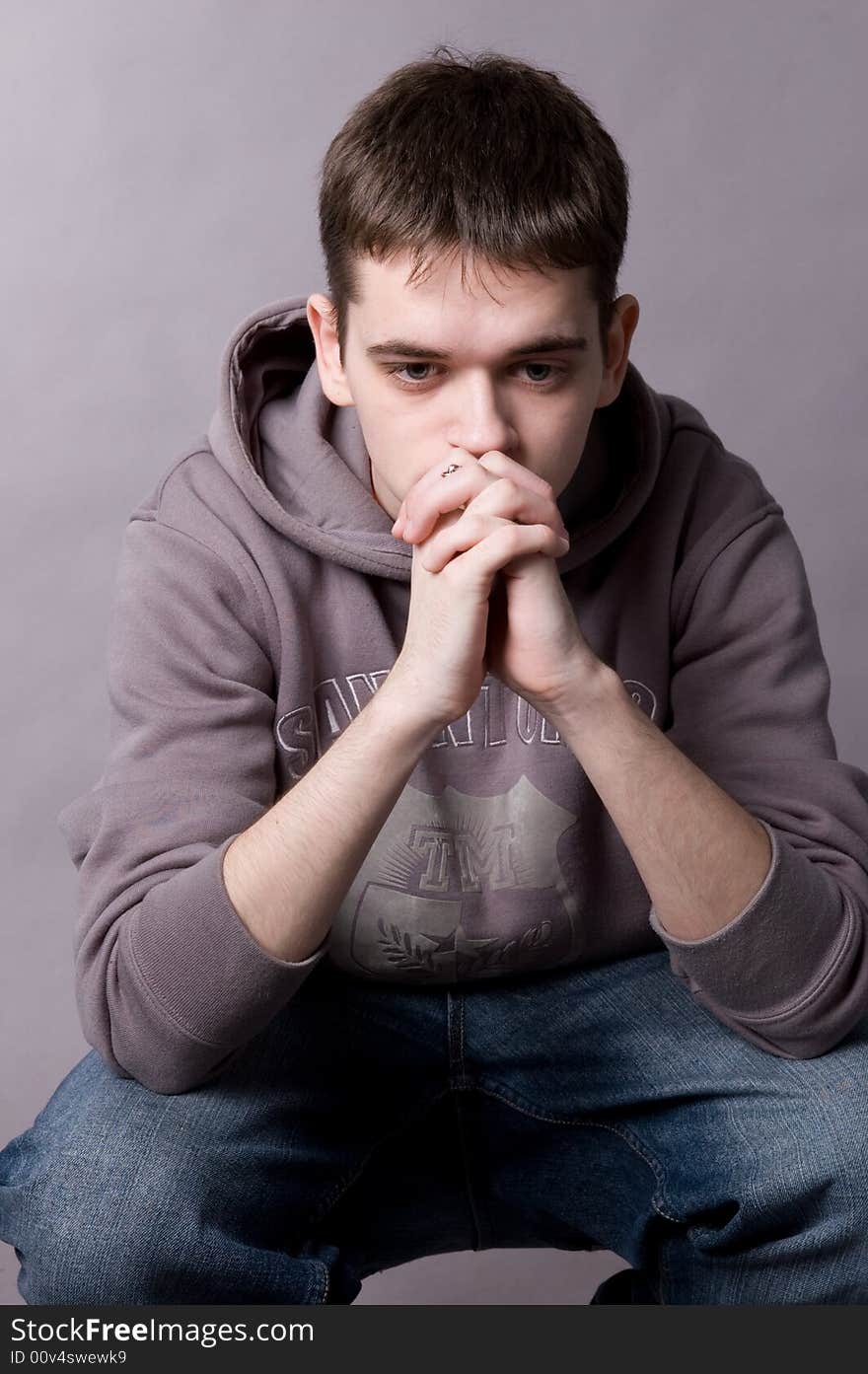 The young guy in studio on a grey background