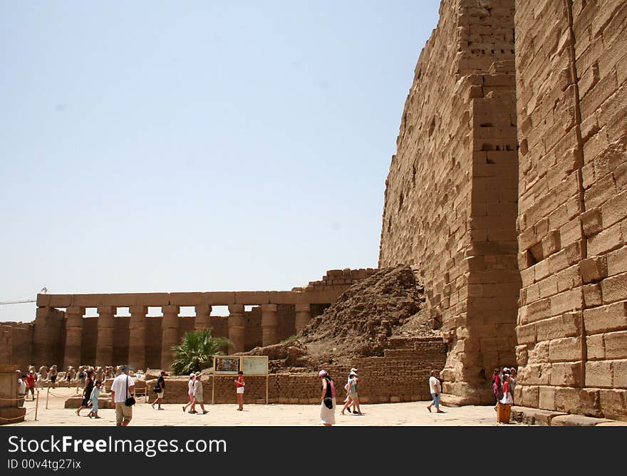 Ancient Luxor ruins, Egypt which are examined by tourists in hot day. Ancient Luxor ruins, Egypt which are examined by tourists in hot day