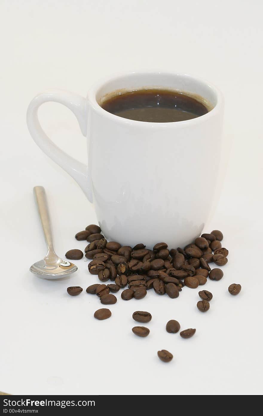 Cup of coffee on white background with a spoon. Cup of coffee on white background with a spoon