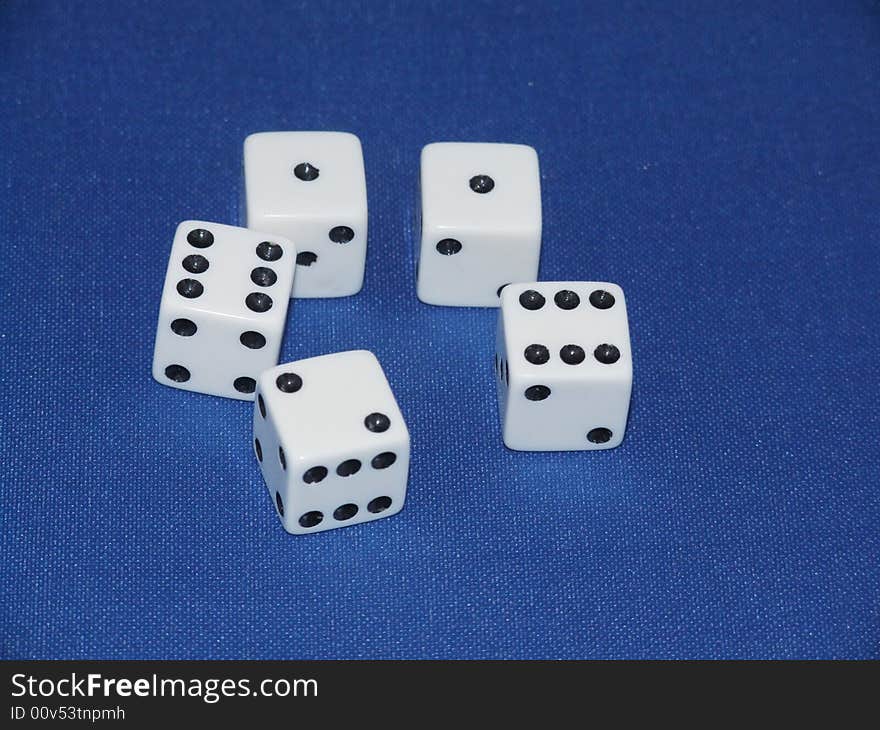 Five dice on a blue baize background