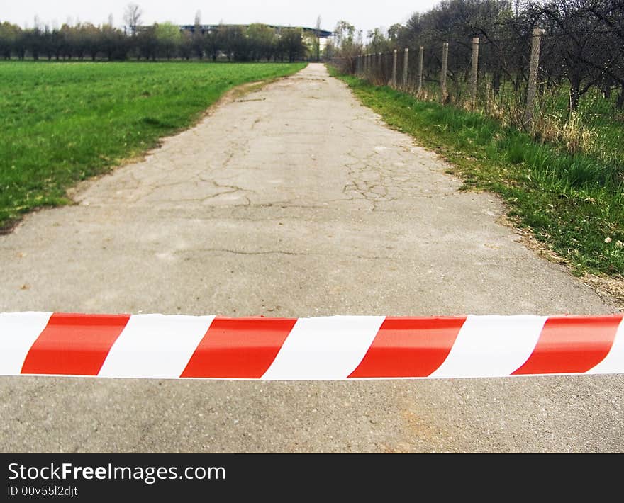 The red - white strip forbidding entrance on road. The red - white strip forbidding entrance on road.