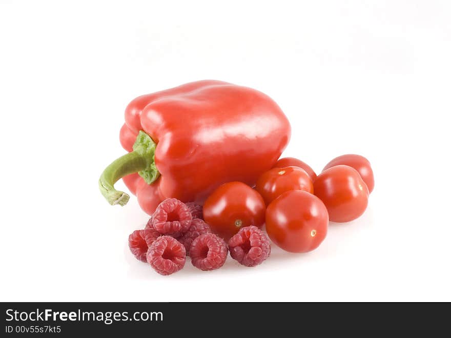 Red paprika, raspberries and cherry tomatoes on a white background. Red paprika, raspberries and cherry tomatoes on a white background.