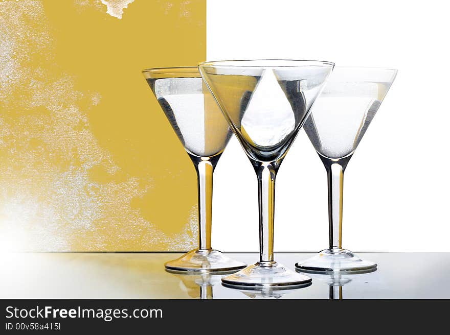 Three glasses for martini with yellow reflection