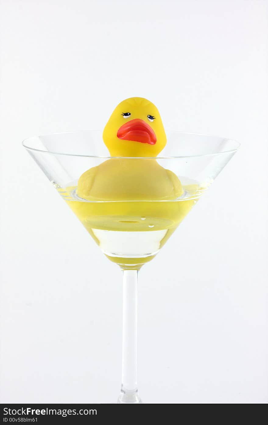 A rubber duck swimming in a cocktail glass