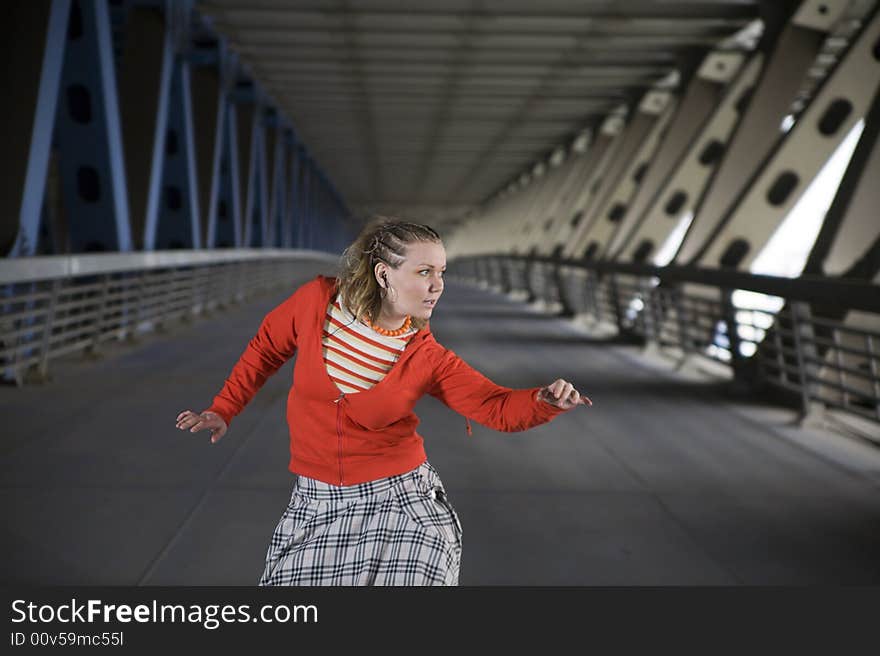 Young beautiful woman listn music and dancing at bridge. Young beautiful woman listn music and dancing at bridge.