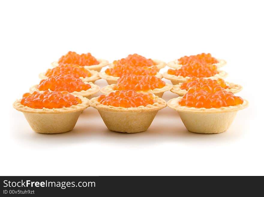 Tartlets with red caviar isolated on a white background. Tartlets with red caviar isolated on a white background