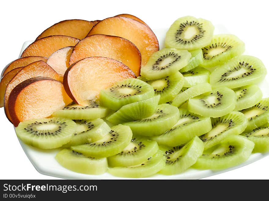 Sliced kiwi and plum on a plate. Isolated on a white background. Clipping path included.