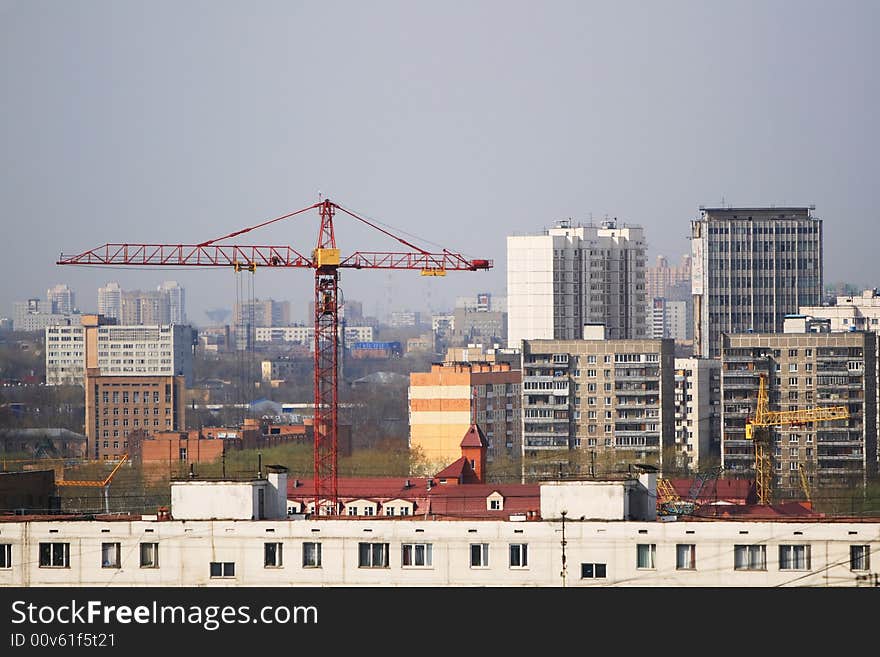 Building red crane among buildings. Building red crane among buildings