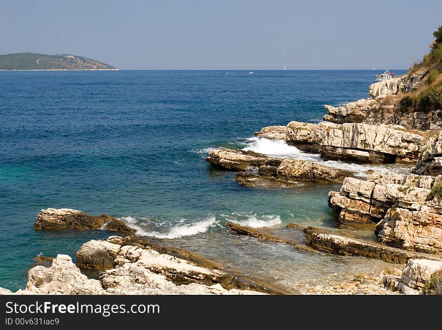 Rocky shore line and blue sea in the summer. Rocky shore line and blue sea in the summer