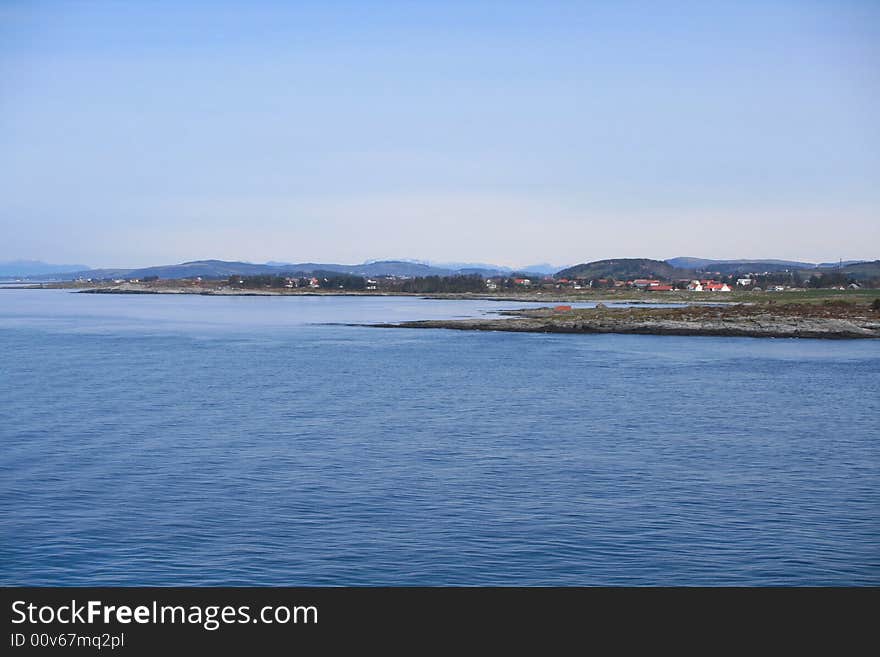 The typical norwegian coastline along a fjord taken from cruise ship between Stavanger and Haugesund.