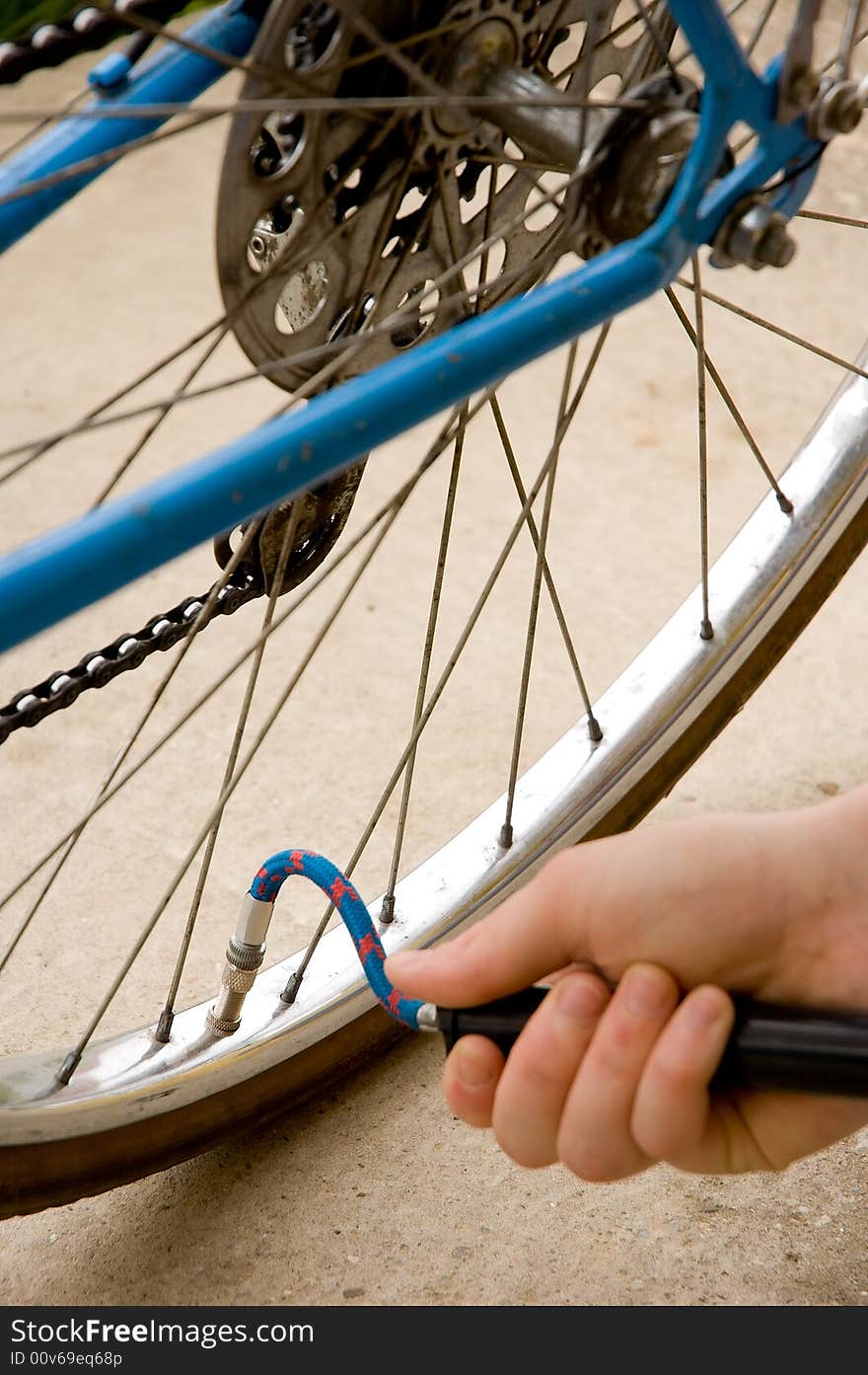 Inflating the tire of a bicycle. Focus is on the valve.