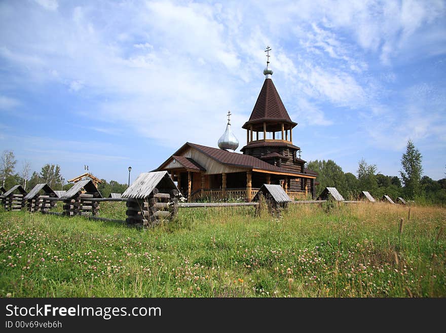 Small wooden church behind a fence