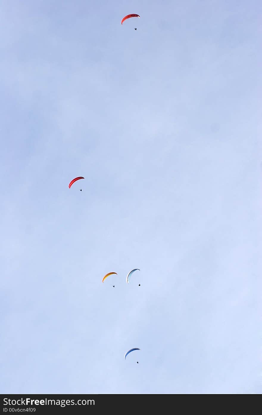 A group of paraglinders in the sky. A group of paraglinders in the sky