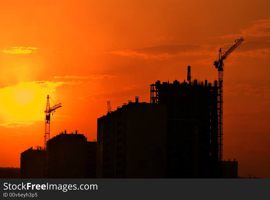 Lifting crane building the house on a construction site. Lifting crane building the house on a construction site