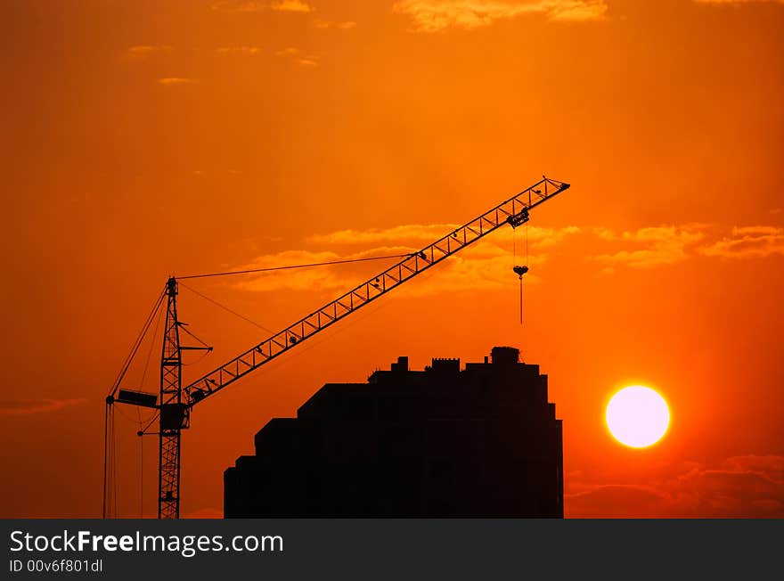 Lifting crane building the house on a construction site. Lifting crane building the house on a construction site