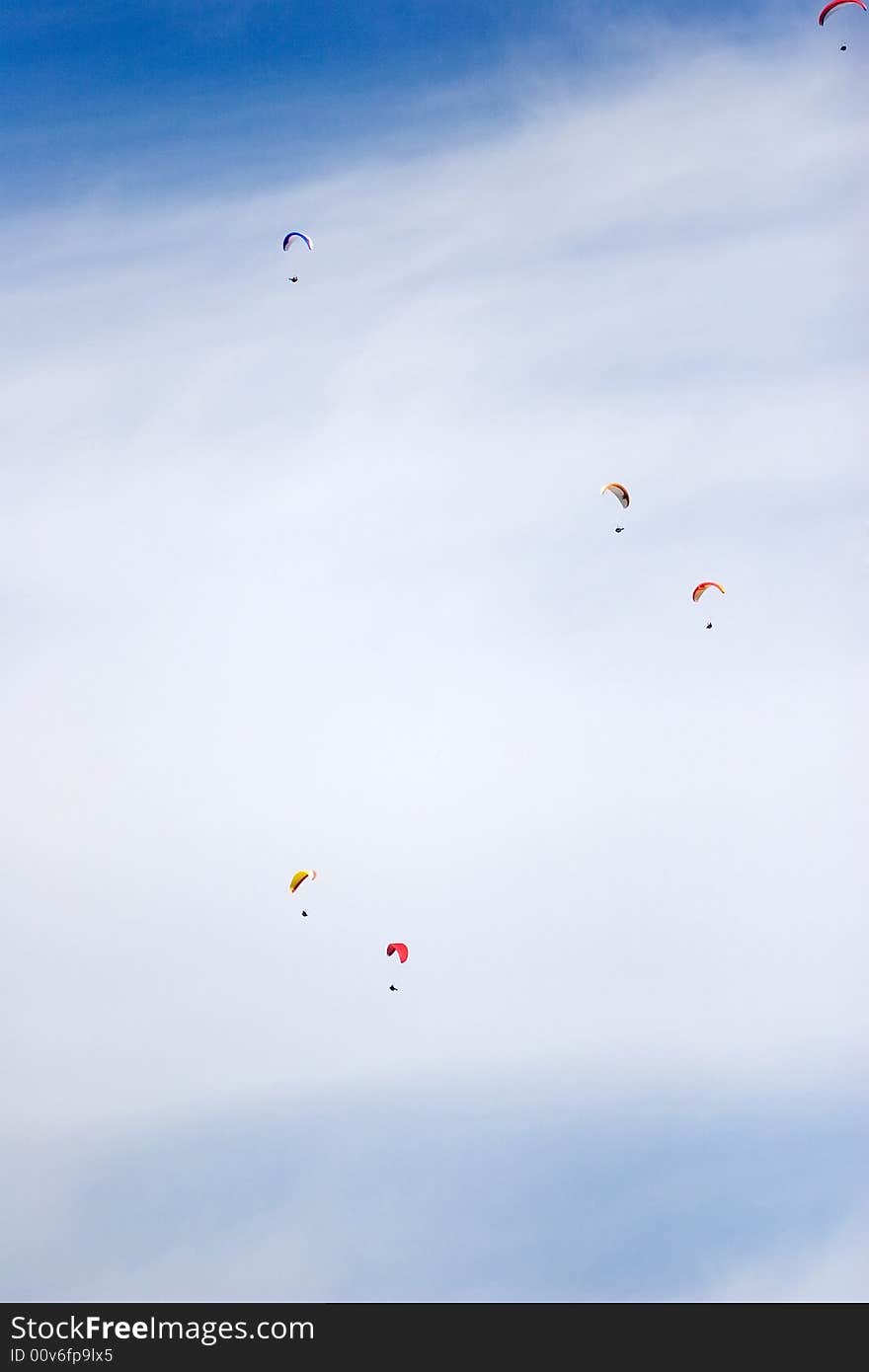 A group of paraglinders in the sky of italy. A group of paraglinders in the sky of italy