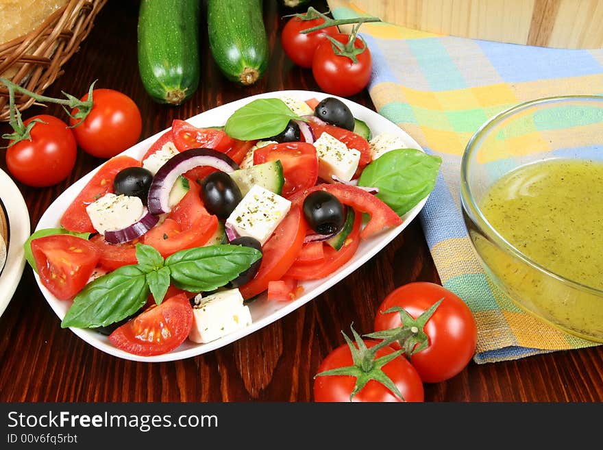 Greek salad with tomatos, mozzarella cheese, onions, olives