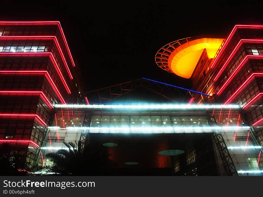 The night falls. In Dongguan young people palace brilliantly illuminated, looks up to the blue color before the front door the glass curtain wall, rose's decorative lighting. Orange UFO modelling.I am as if enter to the science fiction world. The night falls. In Dongguan young people palace brilliantly illuminated, looks up to the blue color before the front door the glass curtain wall, rose's decorative lighting. Orange UFO modelling.I am as if enter to the science fiction world.