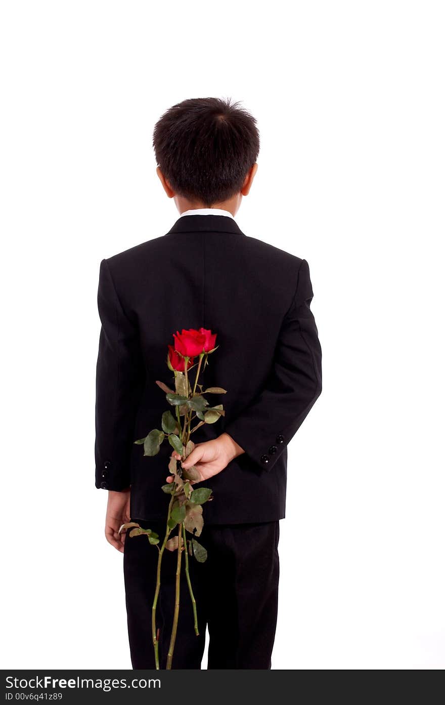 Young man in black suit holding a bunch of flower