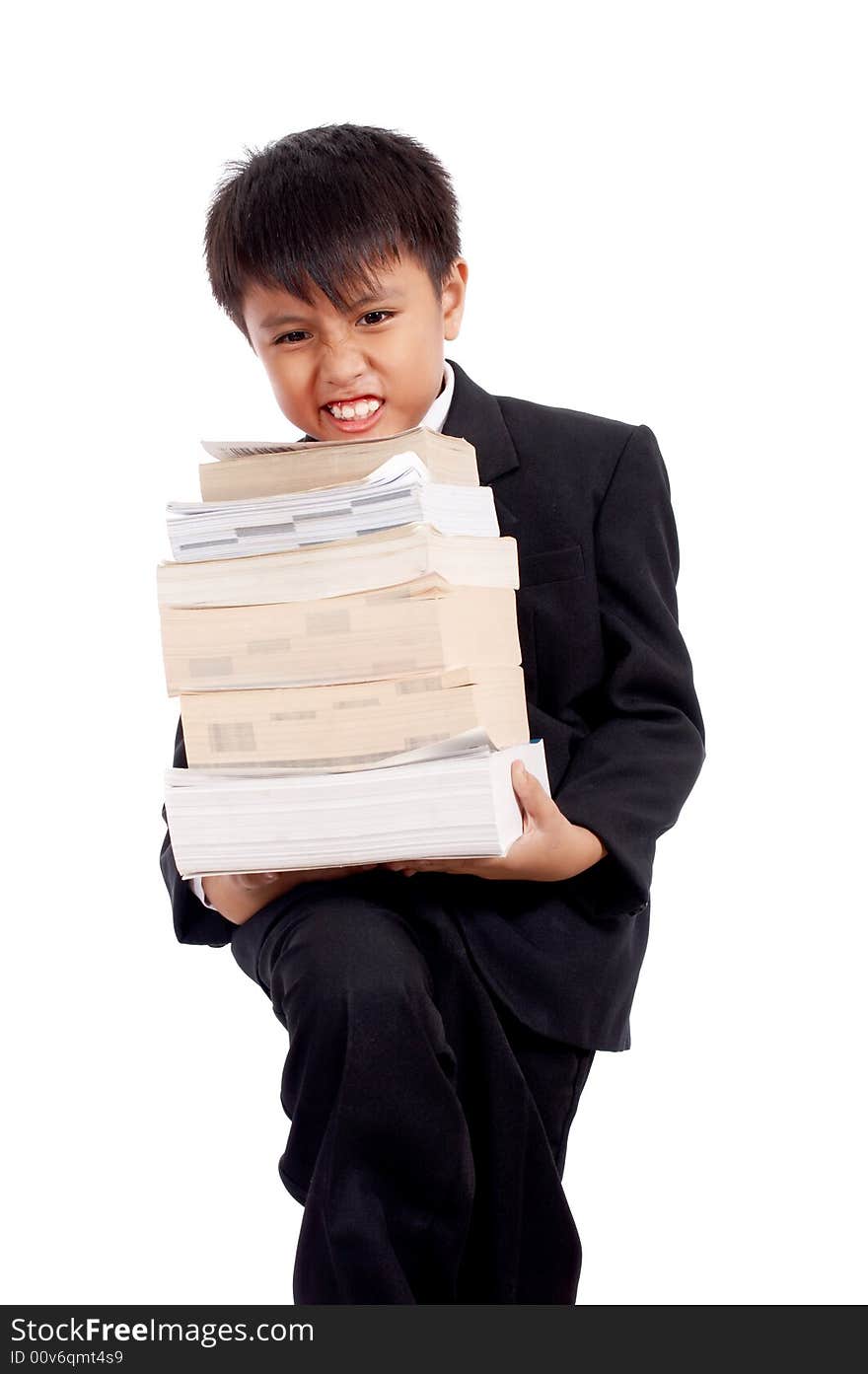 Handsome boy in black suit holding a stack of books