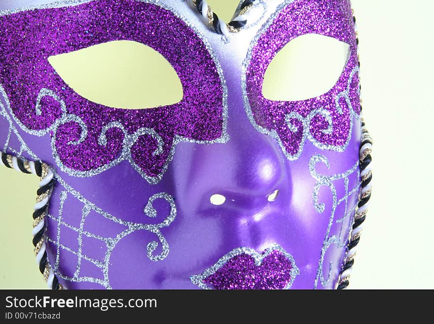 A violet mask on a yellow background