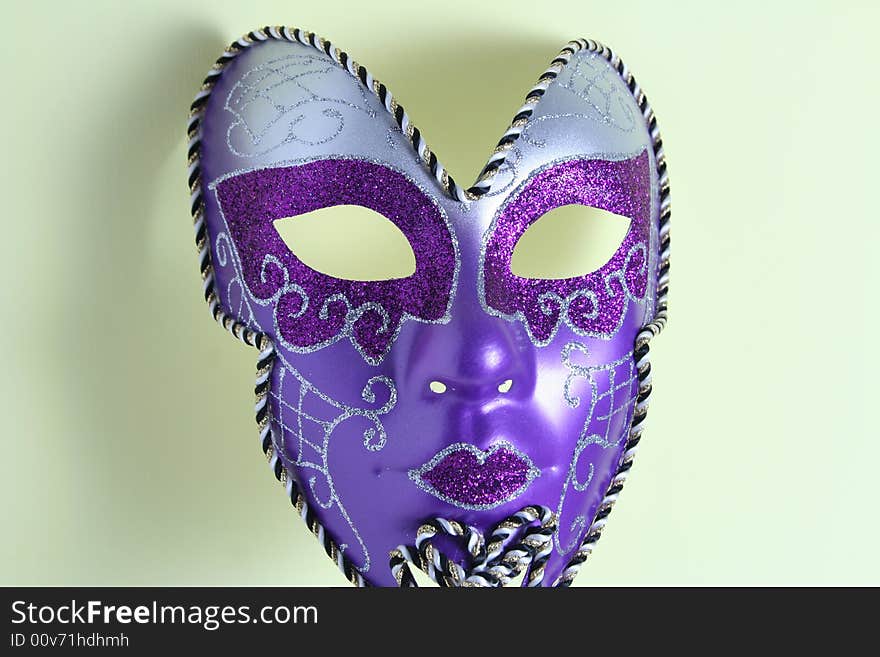 A violet mask on a yellow background